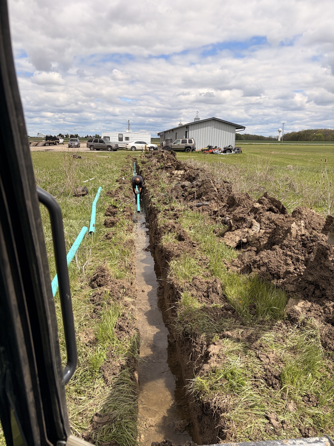 Drainage pipe being installed in a trench